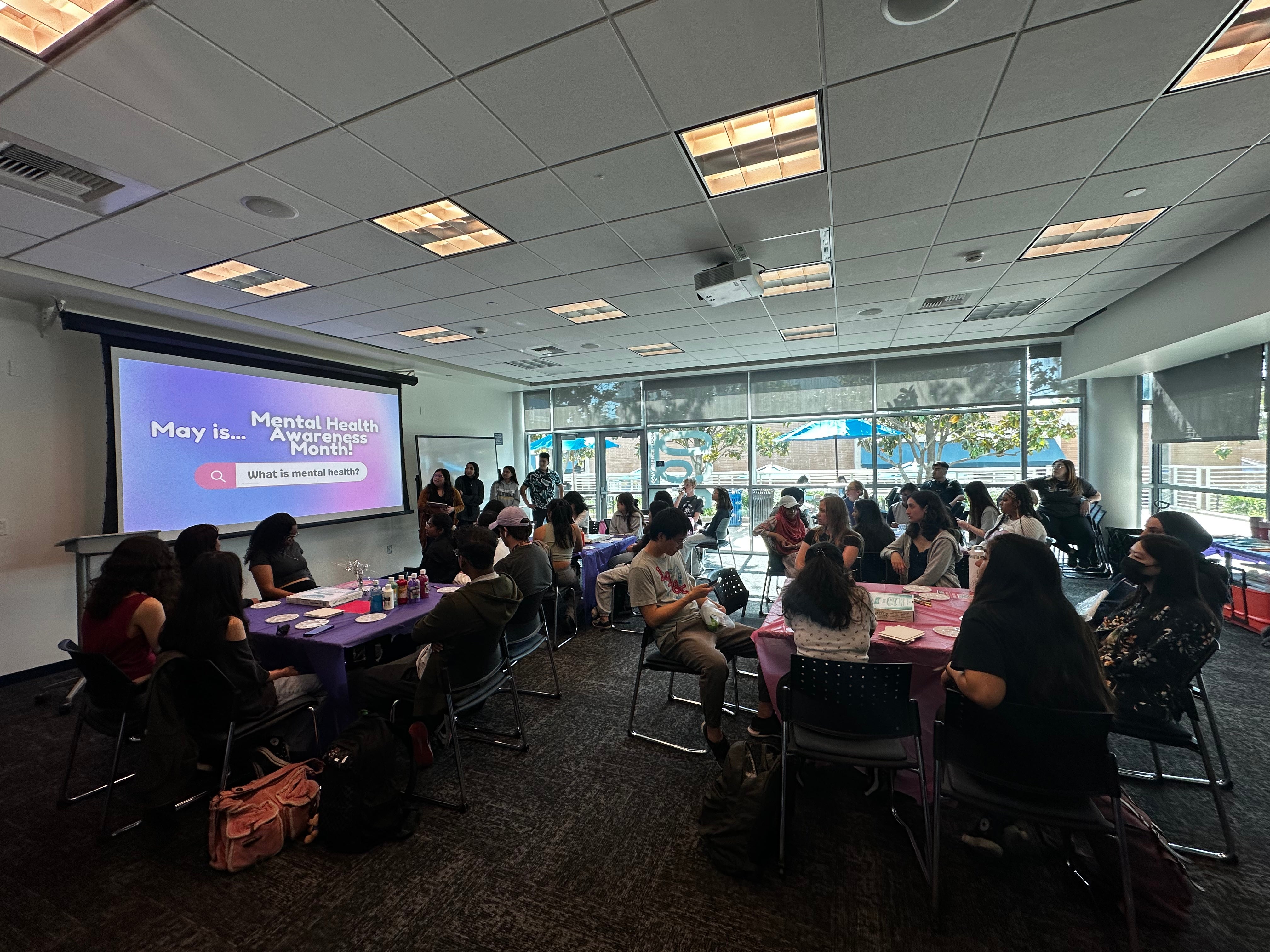 Room full of students receiving presentation. 